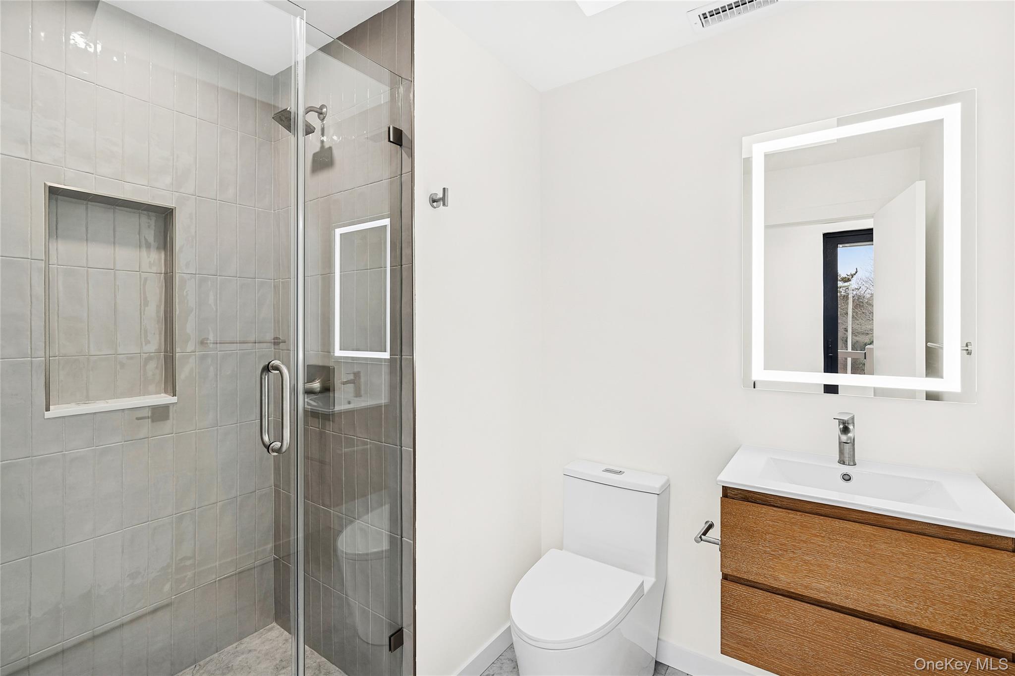 3 Shore Lane Westhampton, NY 11977 - Photo 14 of 17 Bathroom with vanity and a stall shower