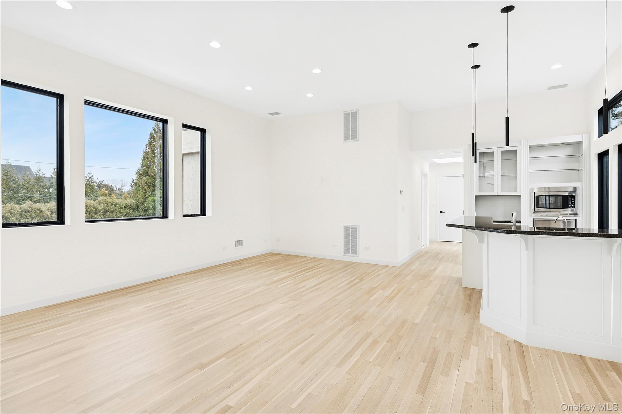 3 Shore Lane Westhampton, NY 11977 - Photo 10 of 17 Unfurnished living room featuring light wood-style flooring and recessed lighting