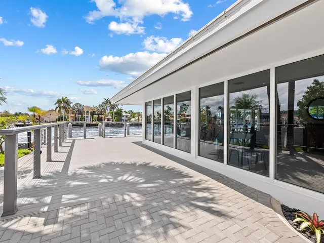 a view of a balcony with wooden floor and iron stairs