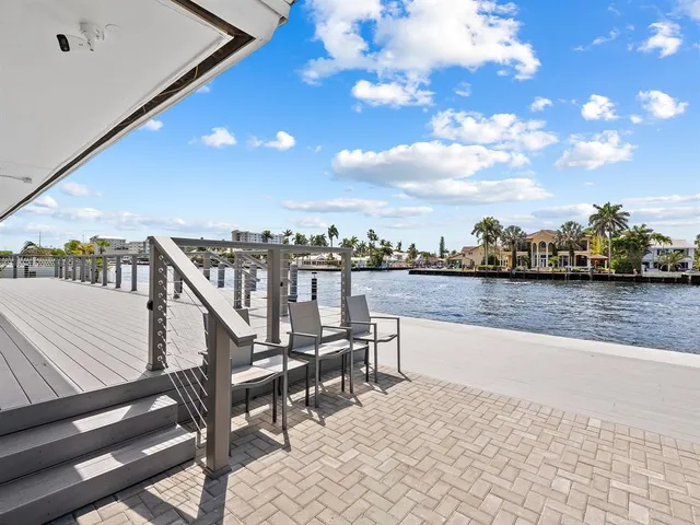 an empty room with furniture and a large window