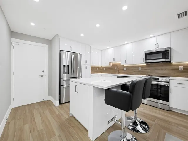 a kitchen with a stove a sink and a microwave