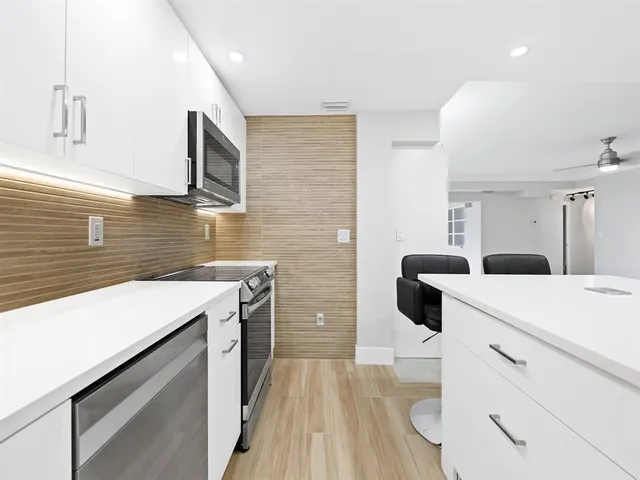 a kitchen with a sink stove and refrigerator