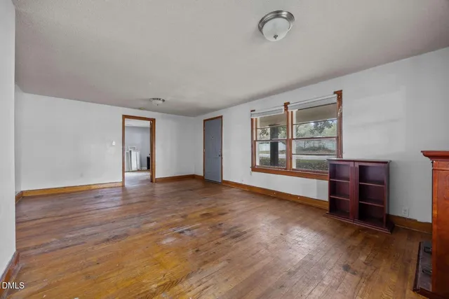 wooden floor in an empty room with a window