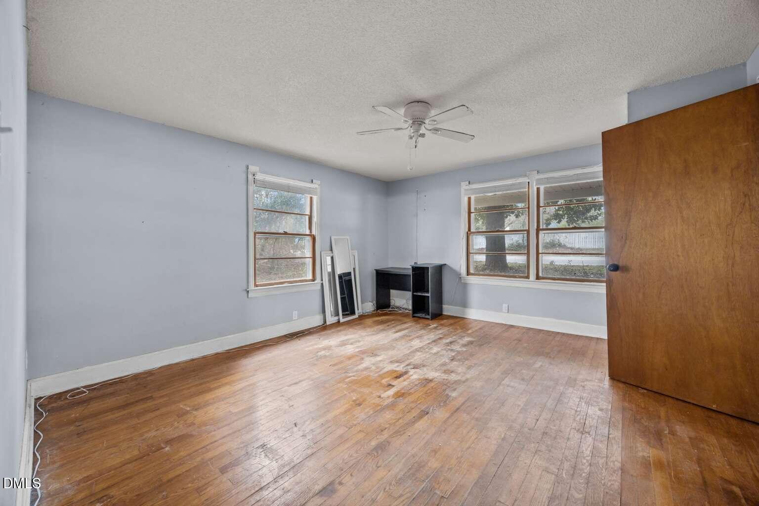 2821 Old Fairground Road Angier, NC 27501 - Photo 15 of 32 a view of an empty room with a window and wooden floor