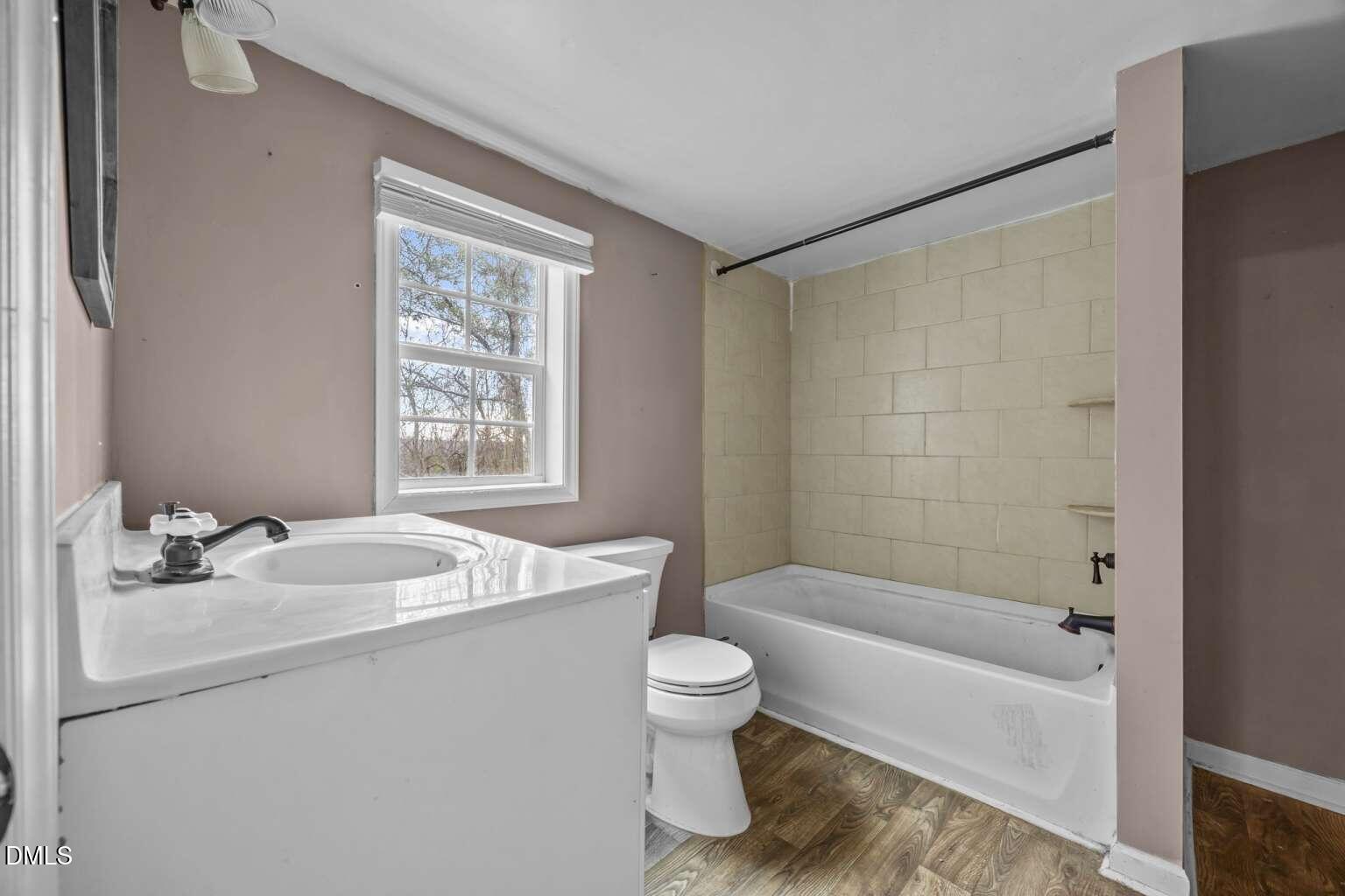 2821 Old Fairground Road Angier, NC 27501 - Photo 20 of 32 a bathroom with a granite countertop sink mirror toilet and bathtub