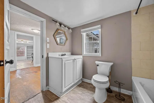 a bathroom with a toilet a sink and a mirror