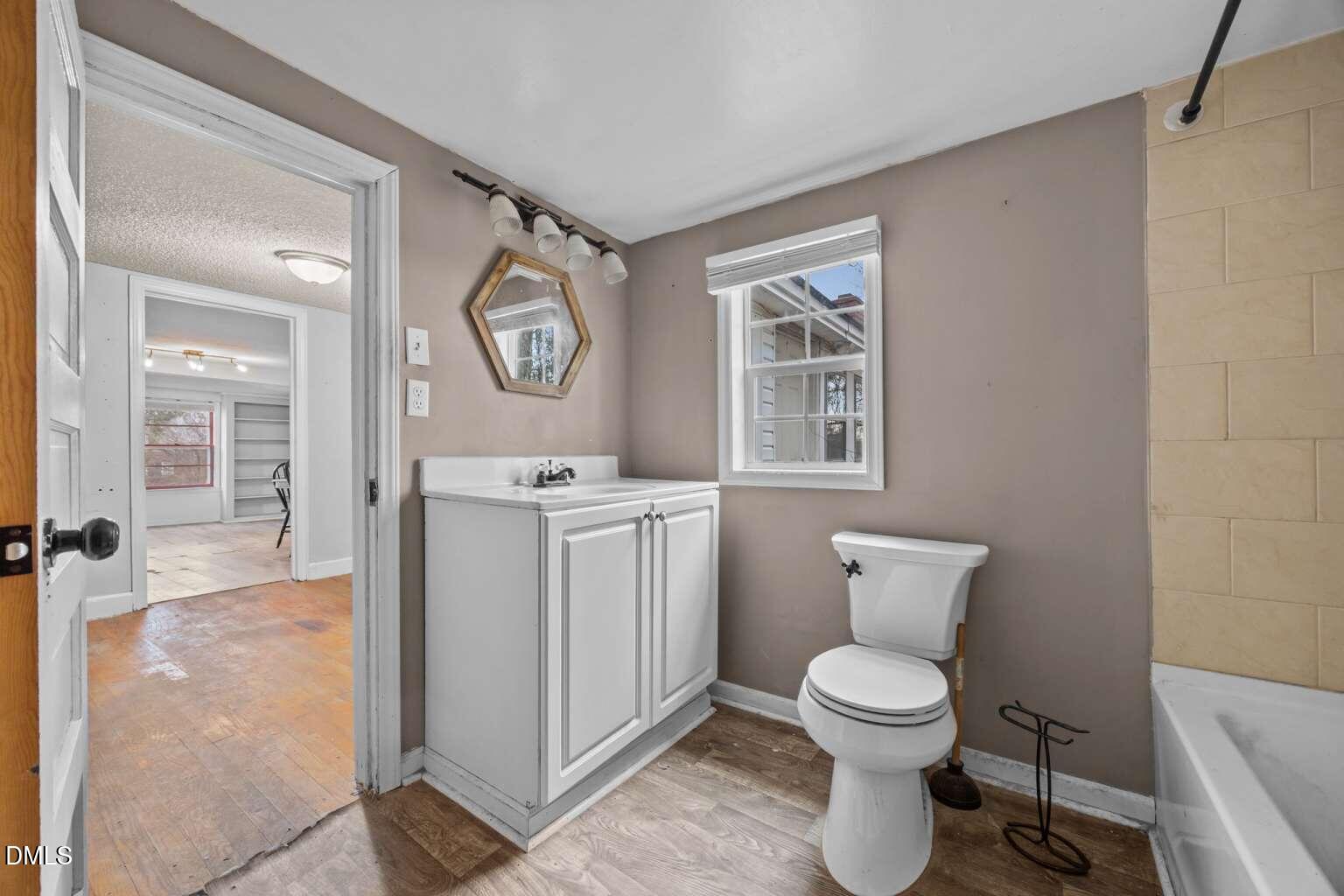 2821 Old Fairground Road Angier, NC 27501 - Photo 21 of 32 a bathroom with a toilet a sink and a mirror