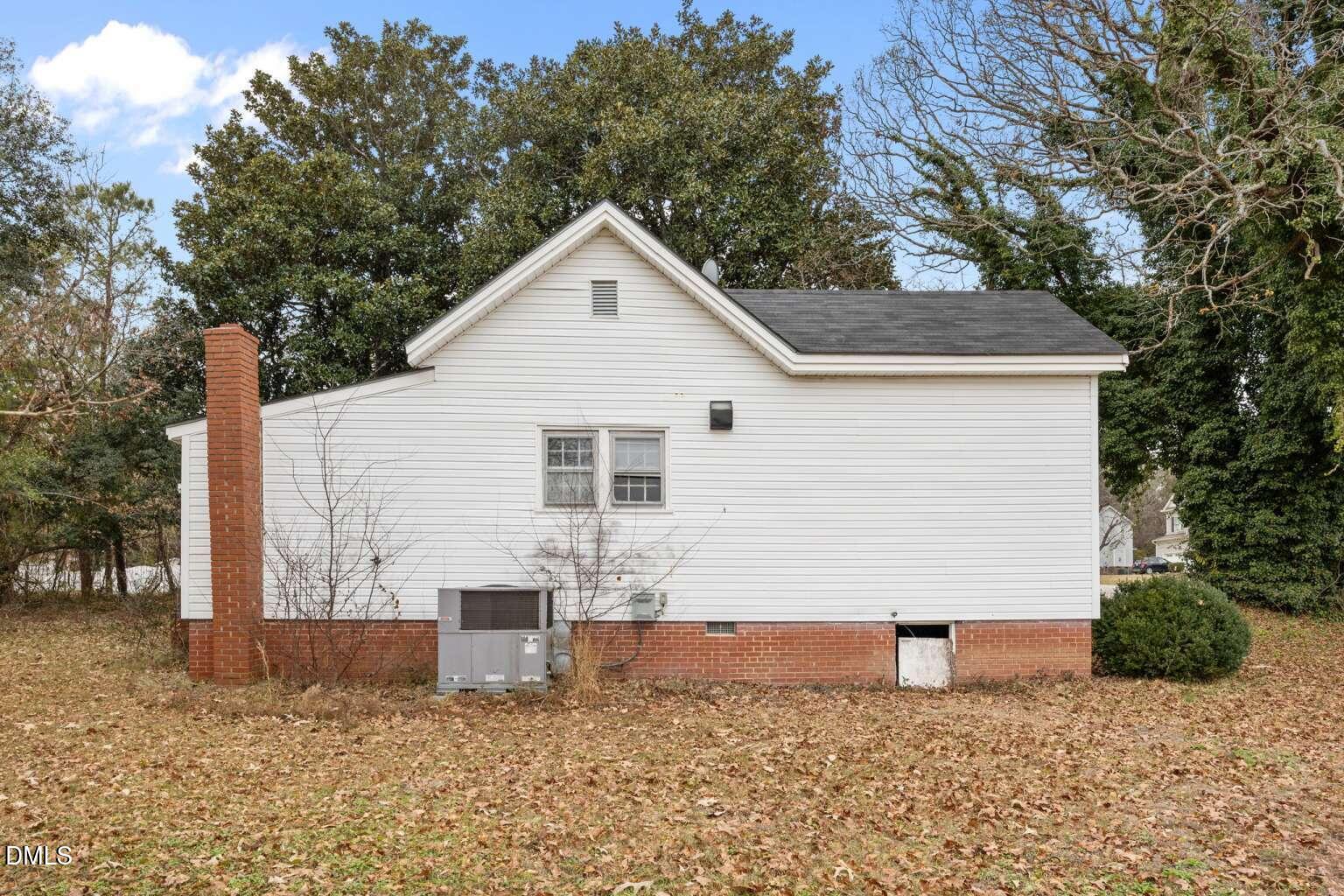 2821 Old Fairground Road Angier, NC 27501 - Photo 27 of 32 a view of a white house next to a yard with large trees