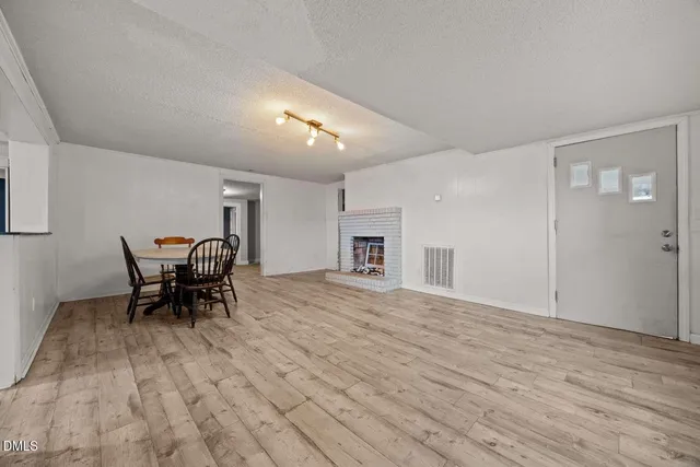 a view of a work space with a table and chairs