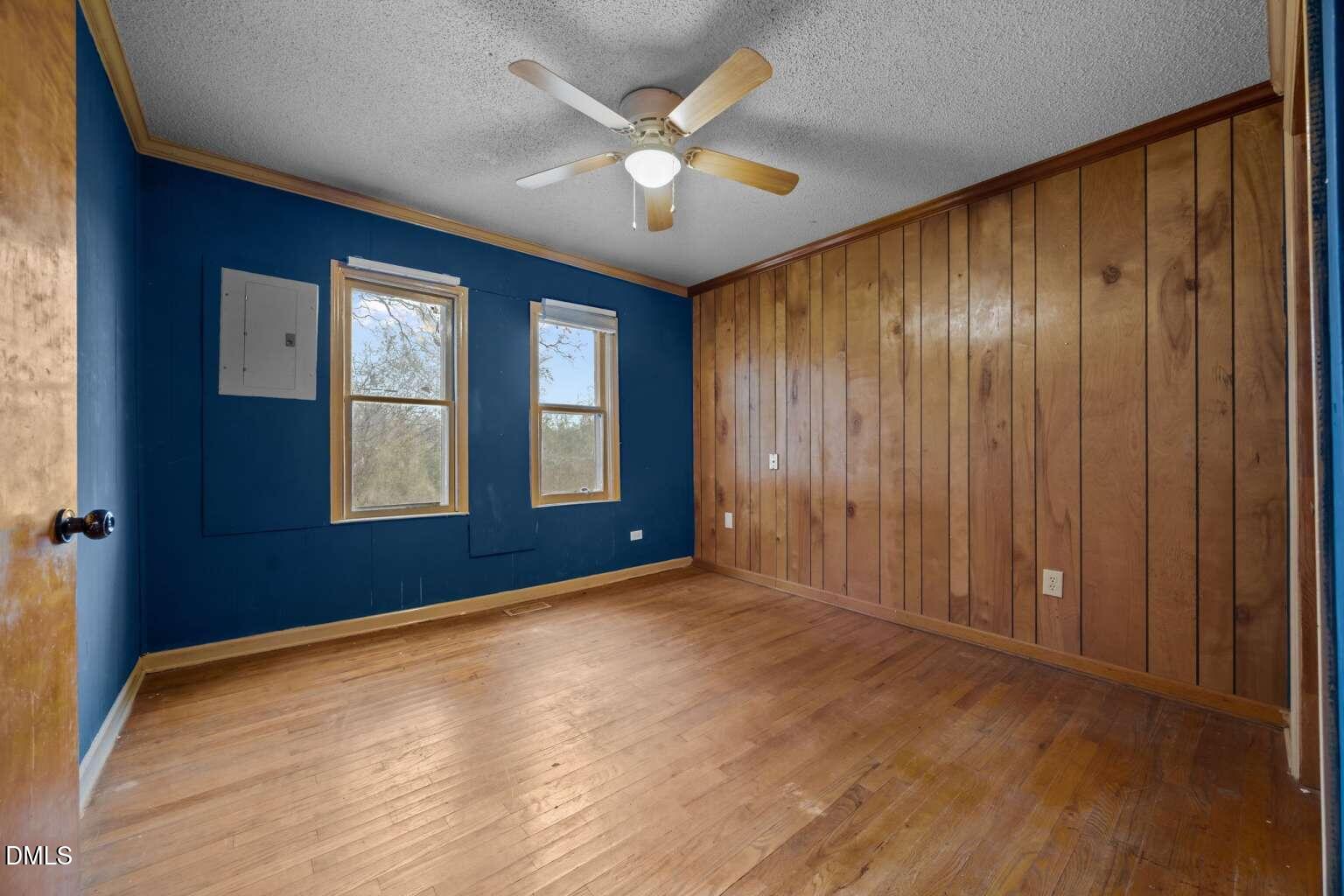 2821 Old Fairground Road Angier, NC 27501 - Photo 9 of 32 an empty room with windows and a ceiling fan