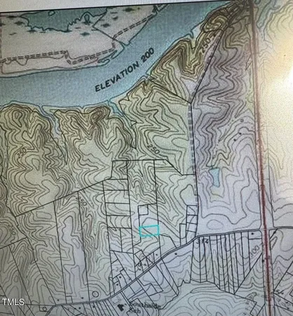 a view of a yard with wooden fence