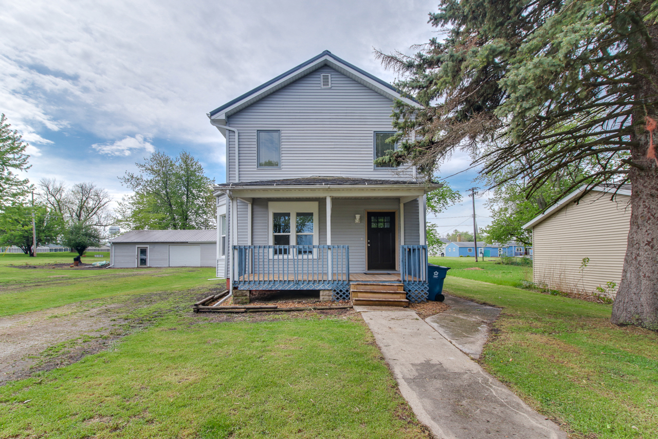 125 Clark Street Chenoa, IL 61726 - Photo 1 of 35 a front view of a house with garden