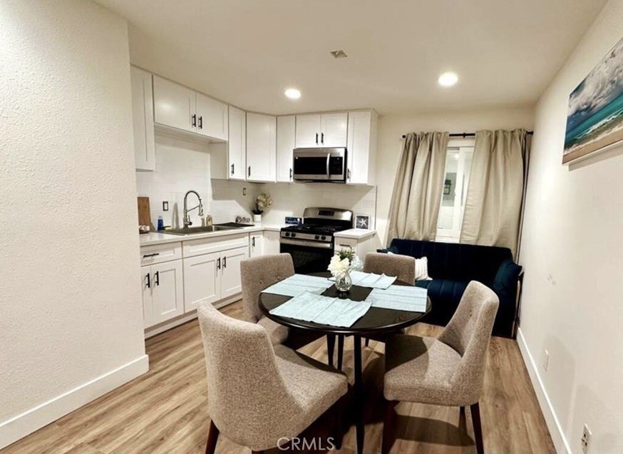 425 Lewis Place Placentia, CA 92870 - Photo 8 of 15 a kitchen with a dining table chairs and a refrigerator