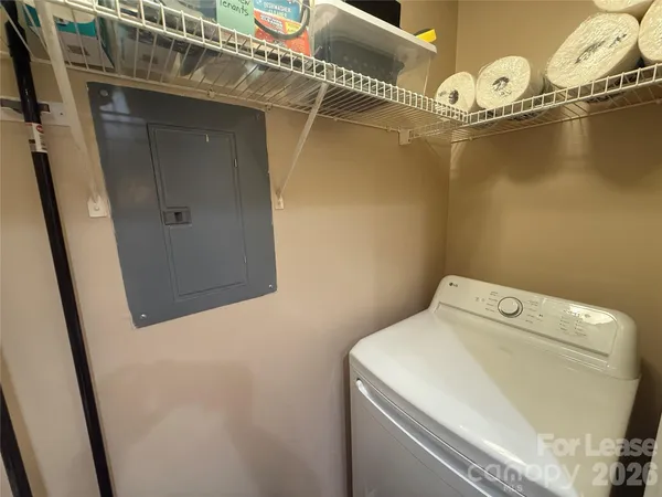 a view of a big room with wooden floor and chandelier