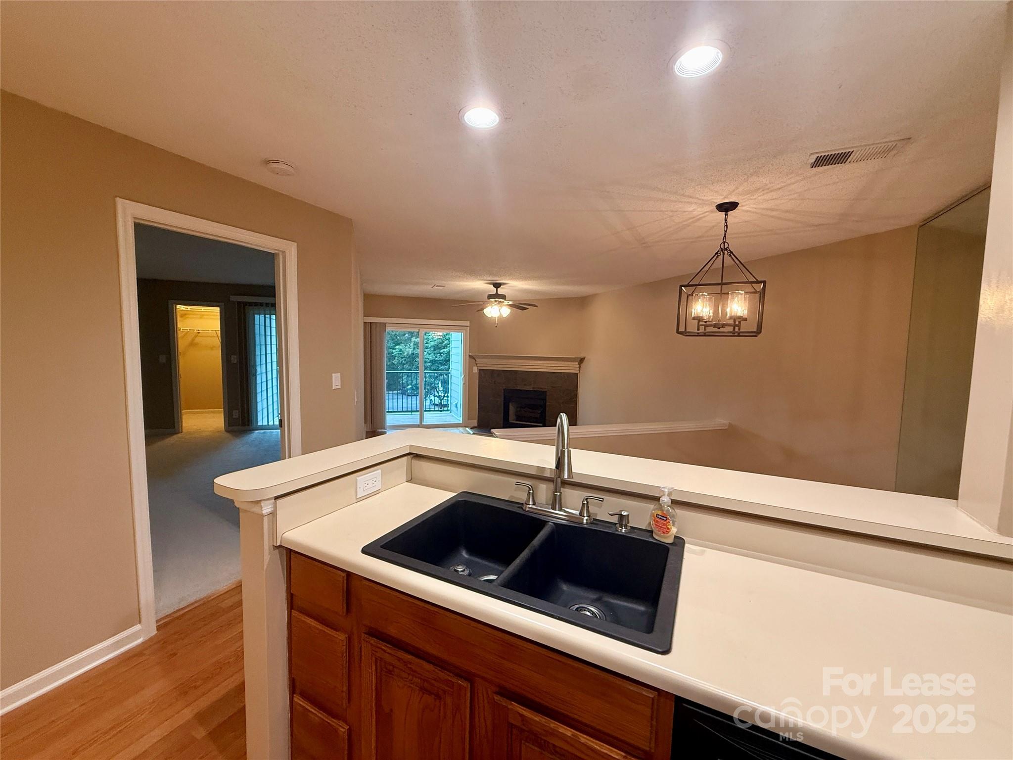 18801 Nautical Drive, Unit 203 Cornelius, NC 28031 - Photo 14 of 28 a kitchen with a sink and a refrigerator