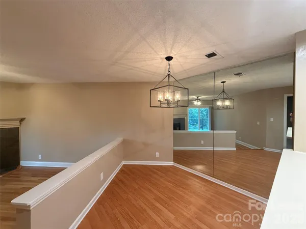 a view of an empty room with a fireplace and a window