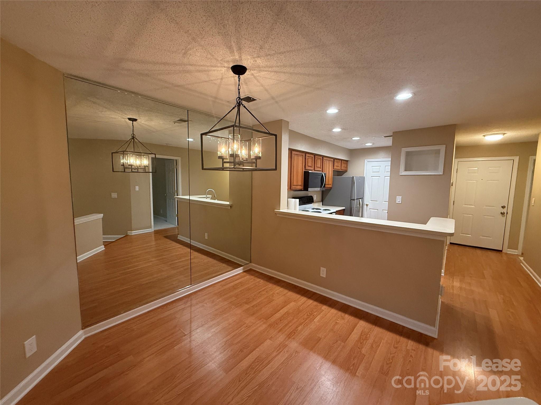 18801 Nautical Drive, Unit 203 Cornelius, NC 28031 - Photo 16 of 28 a view of a kitchen with a sink and wooden floor