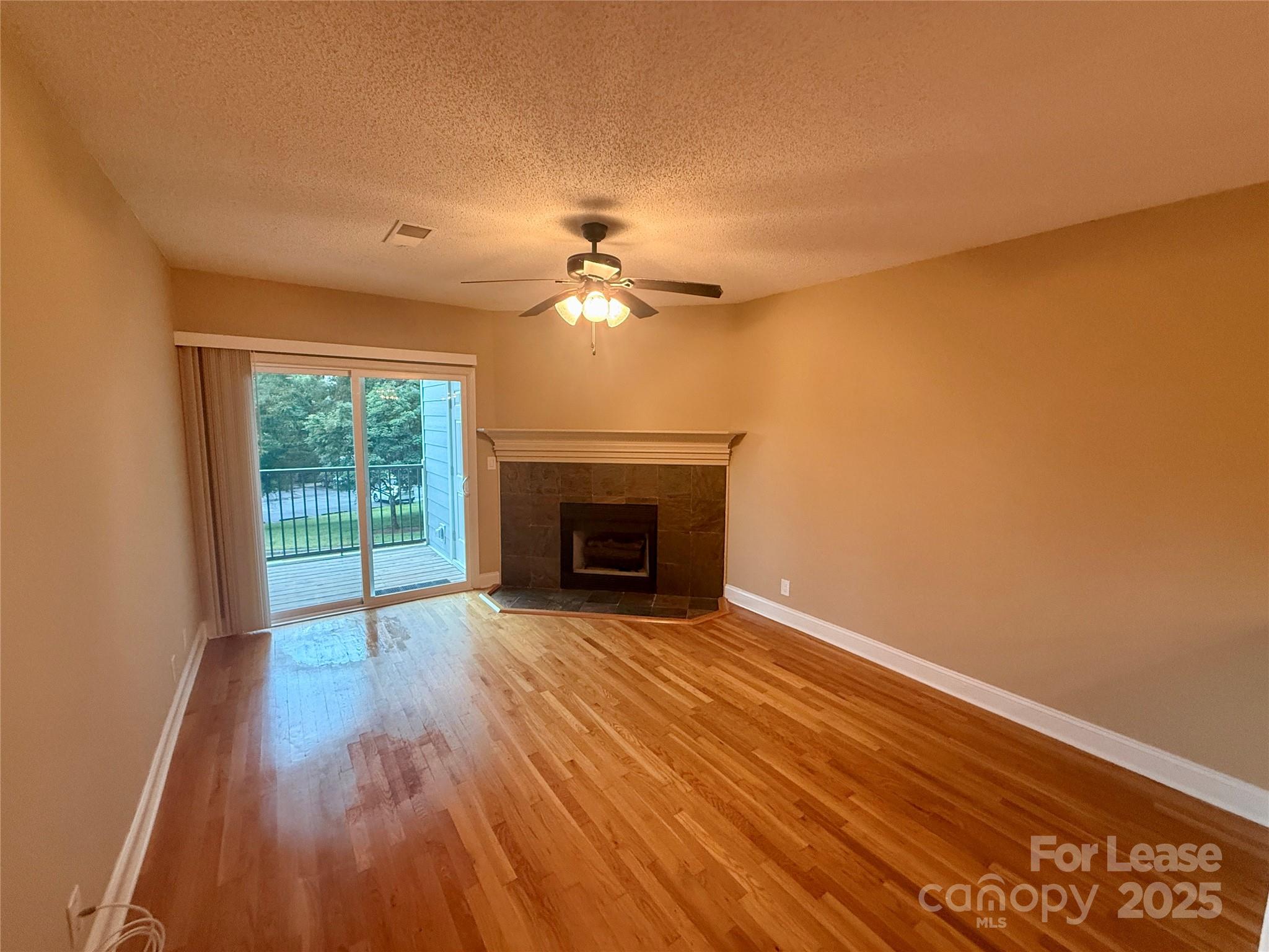 18801 Nautical Drive, Unit 203 Cornelius, NC 28031 - Photo 18 of 28 a view of an empty room with a fireplace and a window