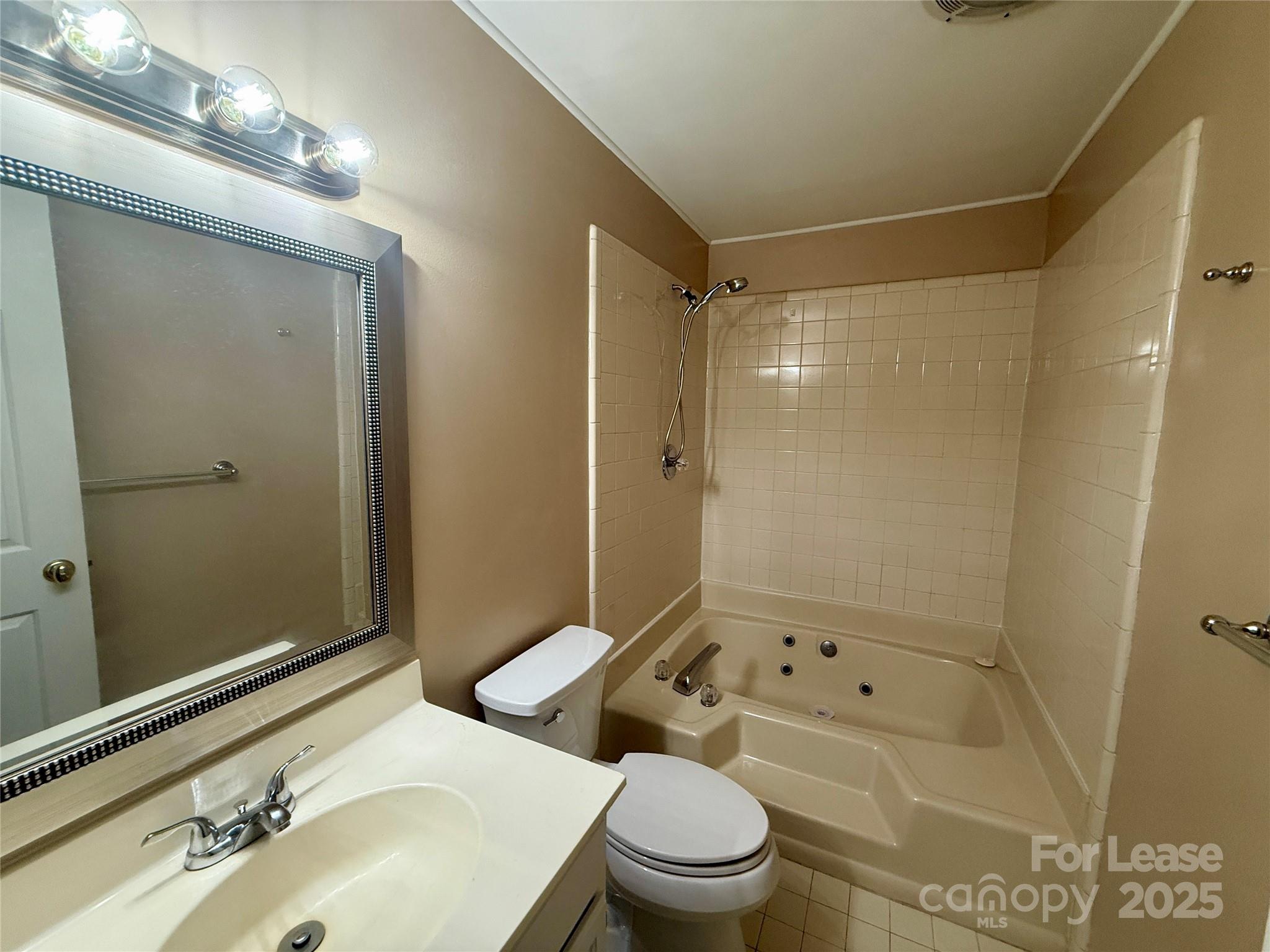 18801 Nautical Drive, Unit 203 Cornelius, NC 28031 - Photo 23 of 28 a bathroom with a sink mirror toilet and shower