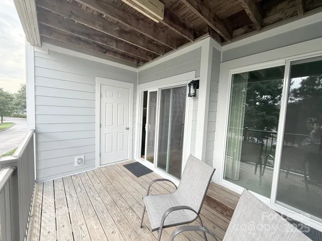 a view of a two chairs in the balcony