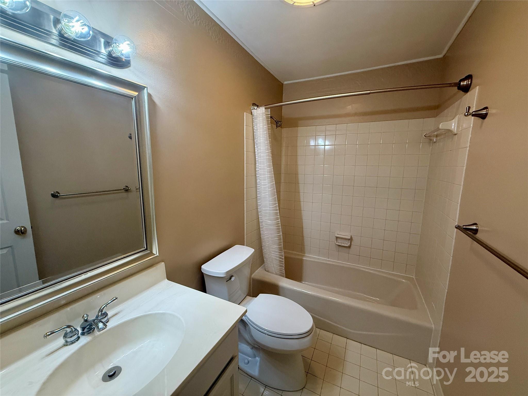 18801 Nautical Drive, Unit 203 Cornelius, NC 28031 - Photo 6 of 28 a bathroom with a sink toilet and shower