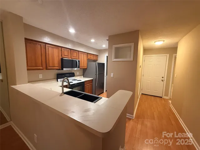 a kitchen that has a sink and a stove in it