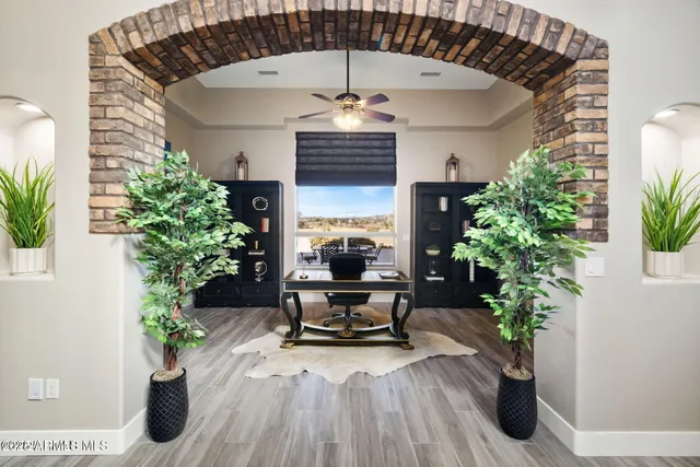 a bathroom with a granite countertop sink a mirror and shower