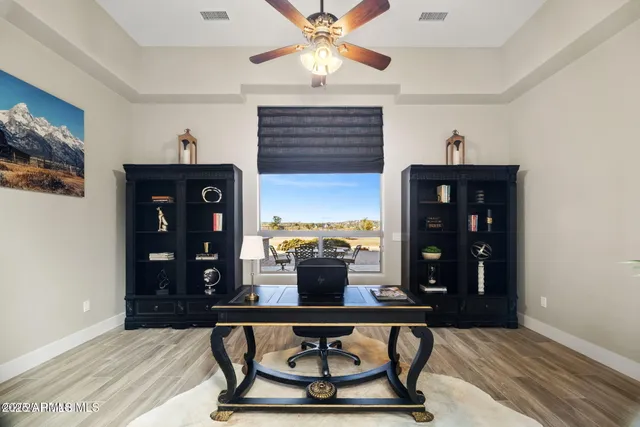 a view of a hallway with wooden floor windows and a kitchen