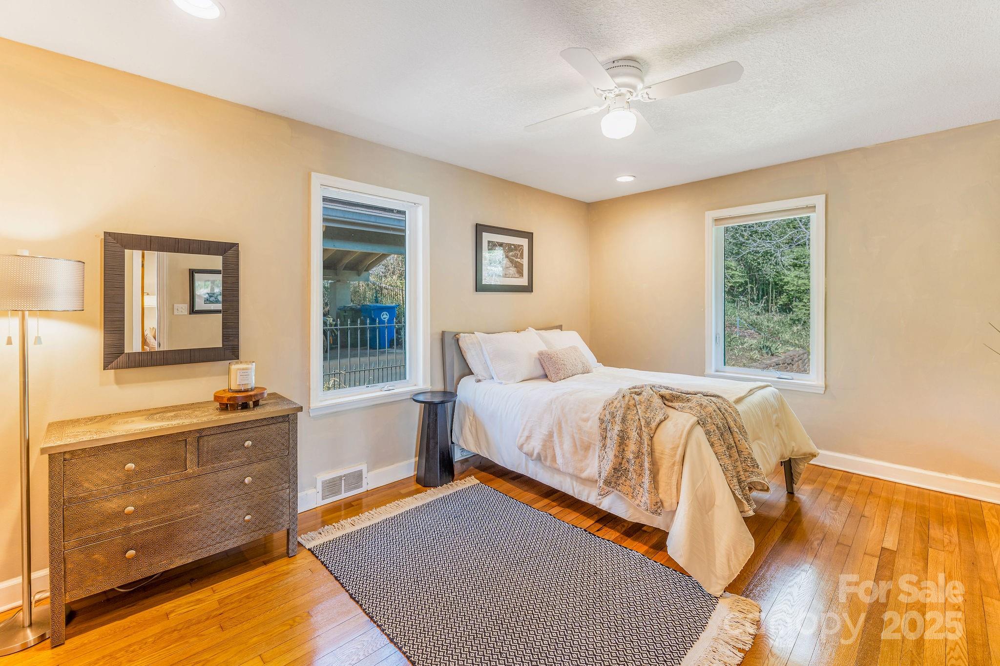 19 Westview Road Asheville, NC 28804 - Photo 24 of 44 a bedroom with a bed and a dresser next to a window