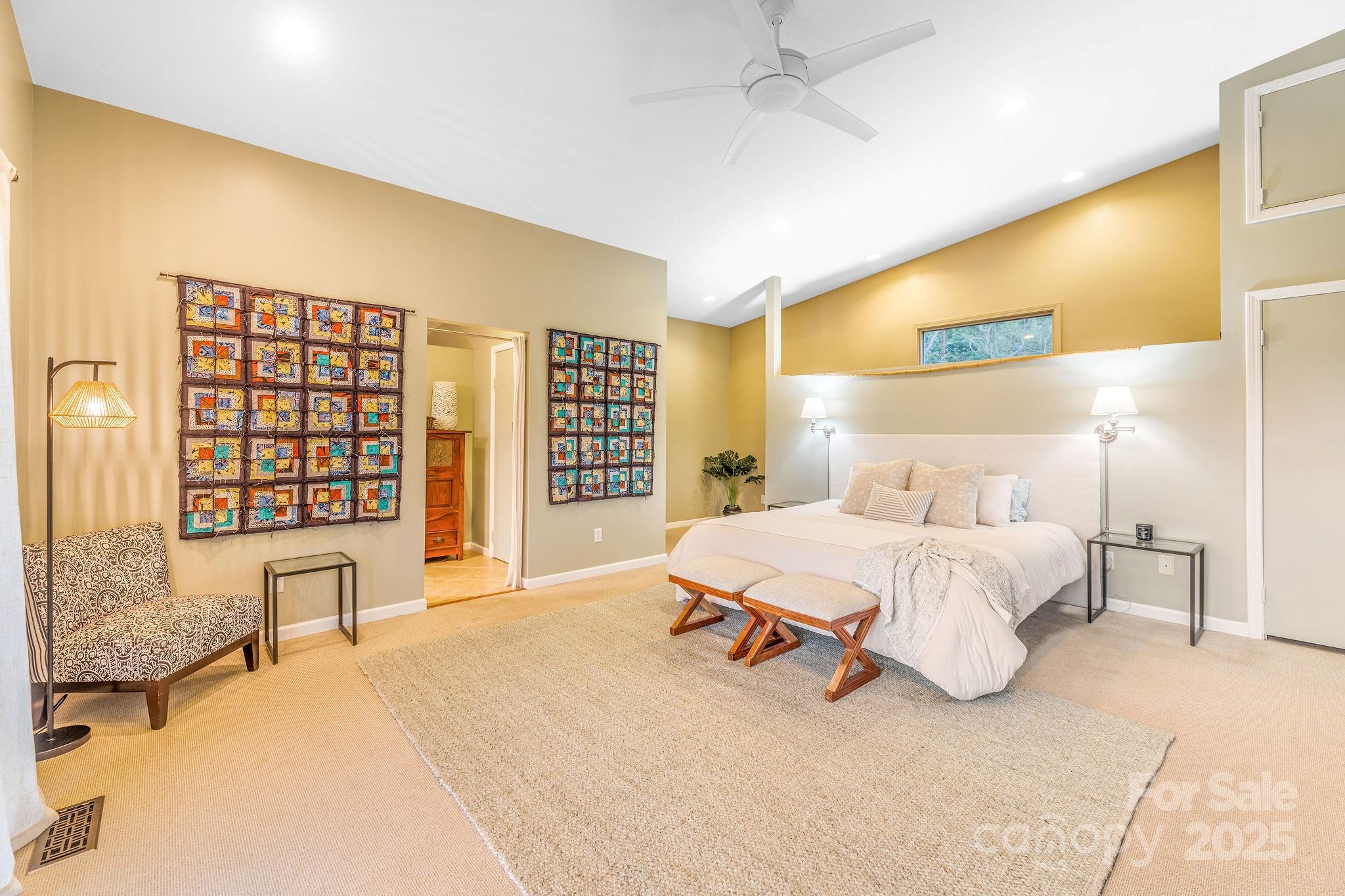 19 Westview Road Asheville, NC 28804 - Photo 27 of 44 a spacious bedroom with a bed a table and chair