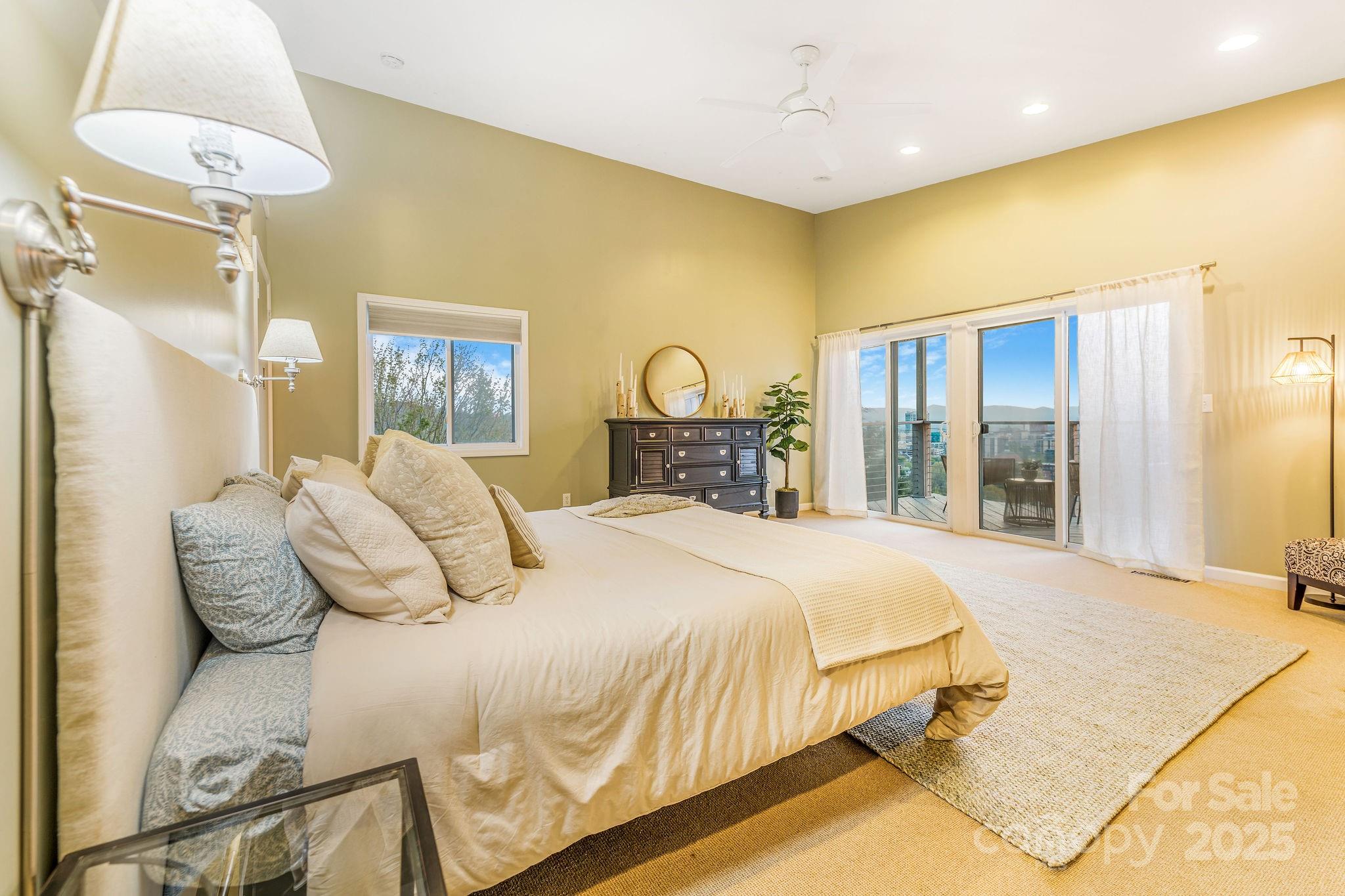 19 Westview Road Asheville, NC 28804 - Photo 28 of 44 a bedroom with a bed and a chandelier