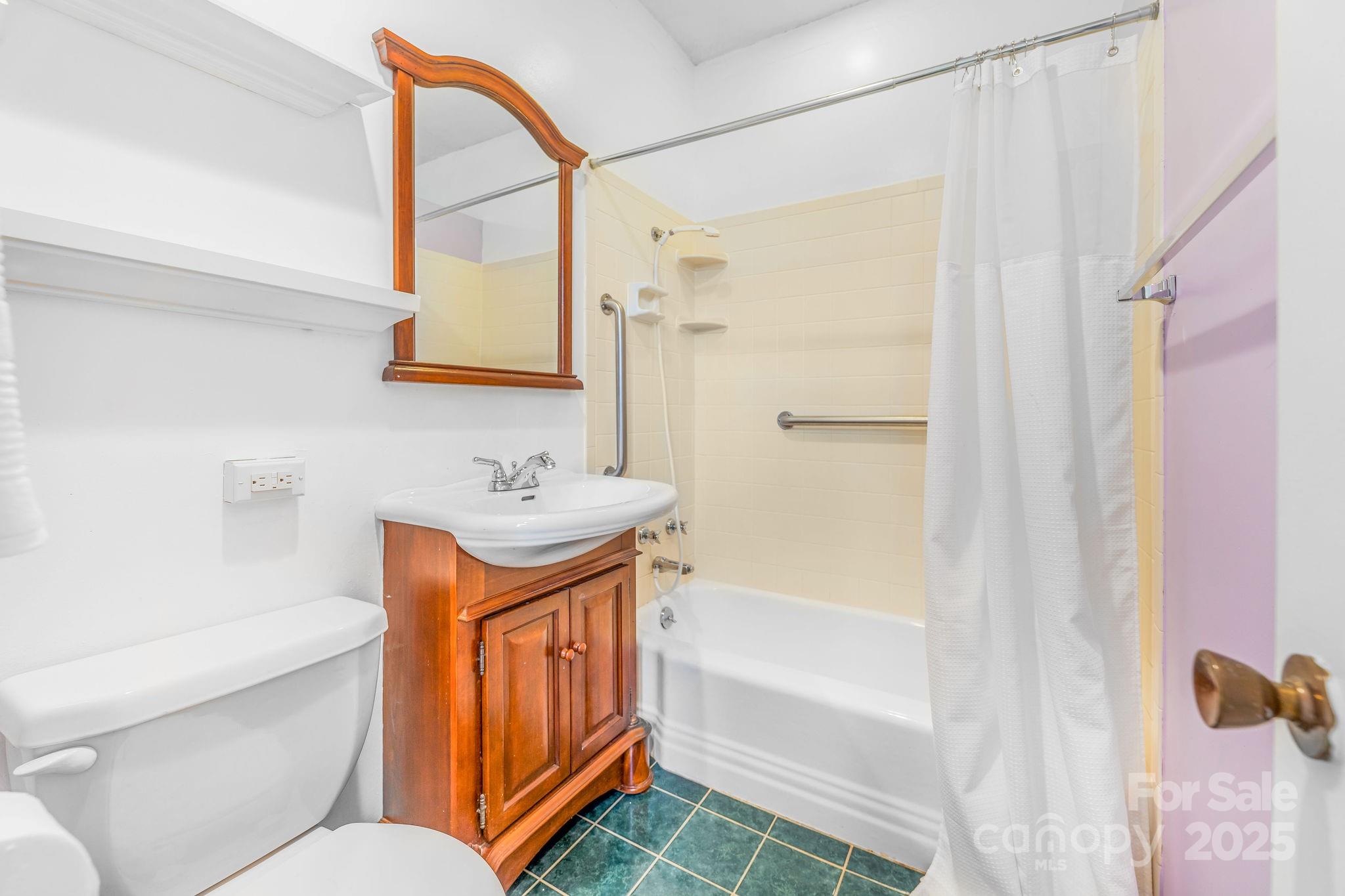 19 Westview Road Asheville, NC 28804 - Photo 37 of 44 a bathroom with a tub sink shower and mirror