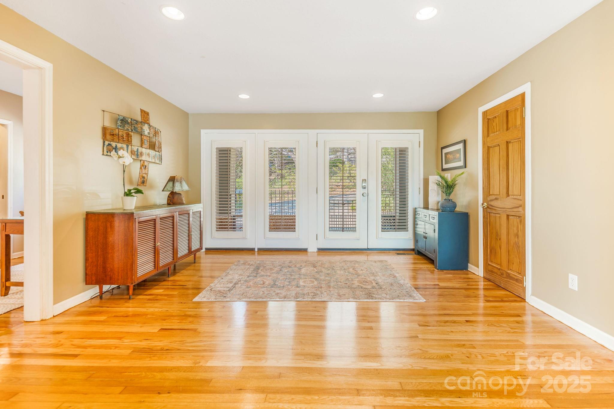 19 Westview Road Asheville, NC 28804 - Photo 7 of 44 a view of an empty room with wooden floor and a window