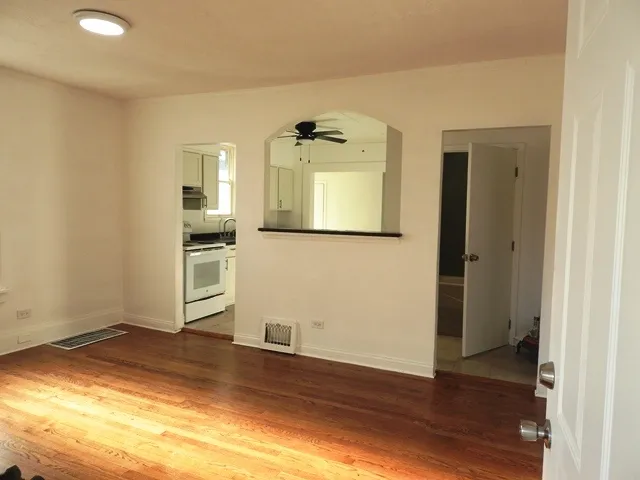 a kitchen with granite countertop a sink a stove and cabinets