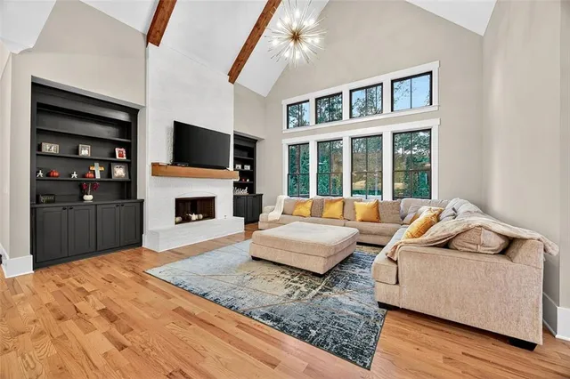 a living room with fireplace furniture and a flat screen tv