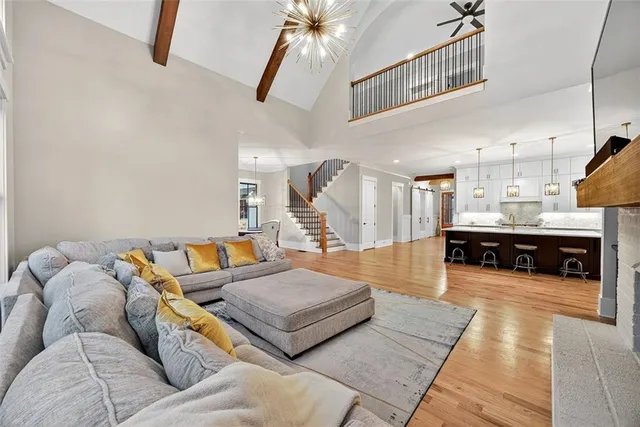 a living room with furniture and a chandelier