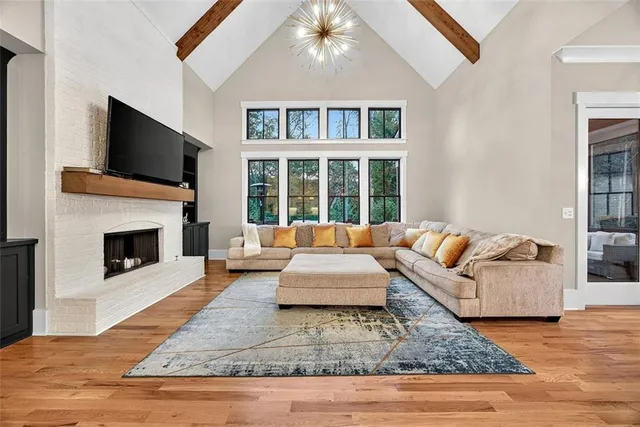 a living room with fireplace furniture and a flat screen tv