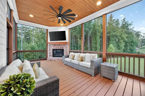 a living room with furniture fireplace and a large window