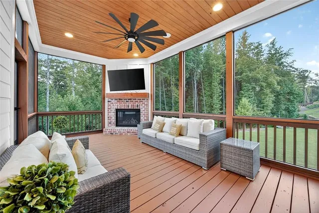 a living room with furniture fireplace and a large window