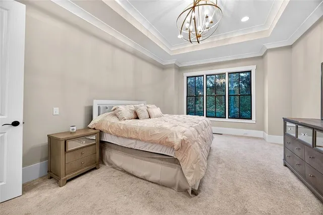 a bedroom with a bed a dresser and a window