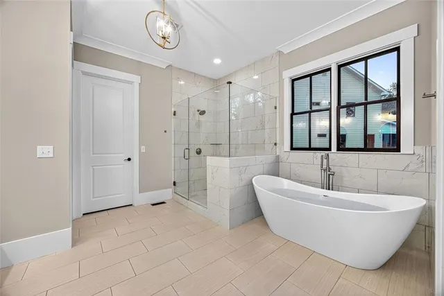a spacious bathroom with a bathtub and a shower