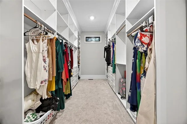 a view of walk in closet with clothes