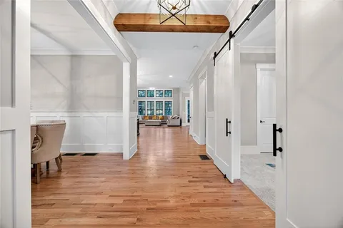 a view of a hallway view with wooden floor and staircase