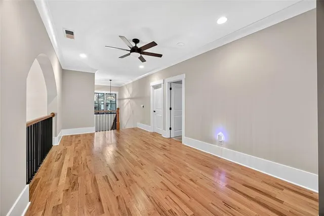 a view of empty room with wooden floor and fireplace