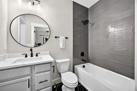 a bathroom with a sink a toilet and a mirror