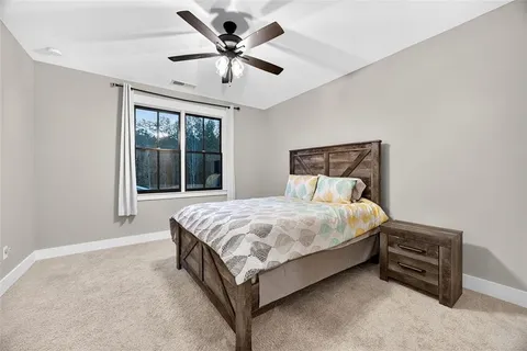 a large bed sitting in a bedroom next to a window