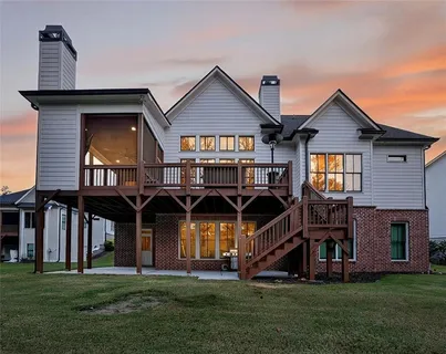 a view of a house with a big yard and large trees