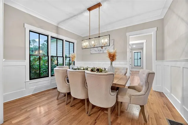 a view of a dining room with furniture window and wooden floor