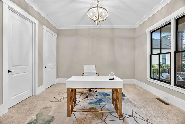 a view of a dining room that has a table and chairs in it