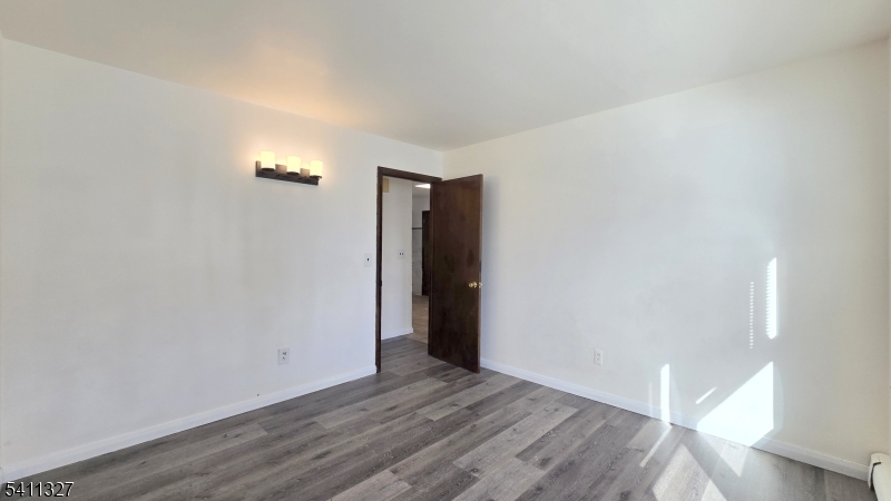 388 Garibaldi Avenue Lodi, NJ 07644 - Photo 14 of 20 a view of an empty room with wooden floor